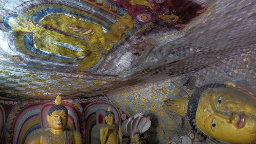 Ancient Buddha figures and wall paintings, colorful and spiritual scene, Dambulla cave temple, Sri