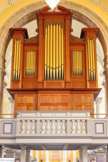 Large wooden organ with golden pipes in a church, Waterford