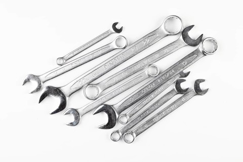 Different sizes of wrenches on white background
