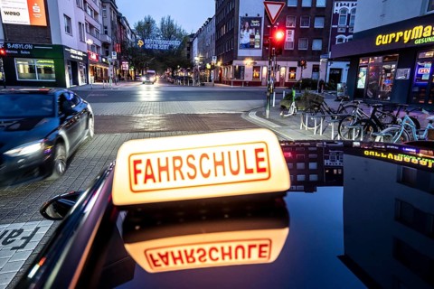Symbolic picture of driving school, evening trip in the city center, urban traffic