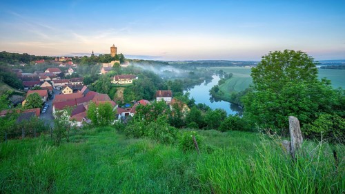 Morning atmosphere in the Saale Valley with morning fog, view of the river Saale and the village of