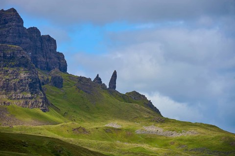 Dramatic mountain landscape with distinctive rocks under a partly cloudy sky, Old Man of Storr,