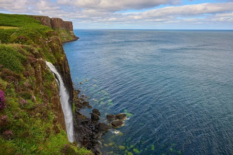 Extensive view of the coast with a dramatic waterfall across the sea, Kilt Rock Waterfall, Portree,