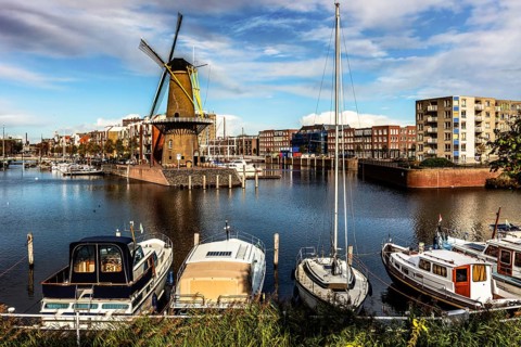 Windmill De Distilleerketel, flour mill in the historic port of Delfshaven, place from which the