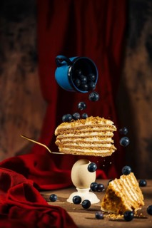 A stunning visual capture showcasing a slice of layered cake speared on a fork, suspended with