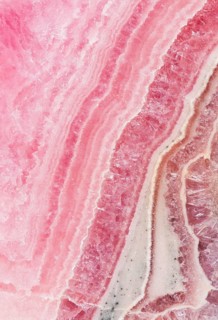 Detailed macro image of rhodochrosite, manganese carbonate, showcasing its striking pink hues,