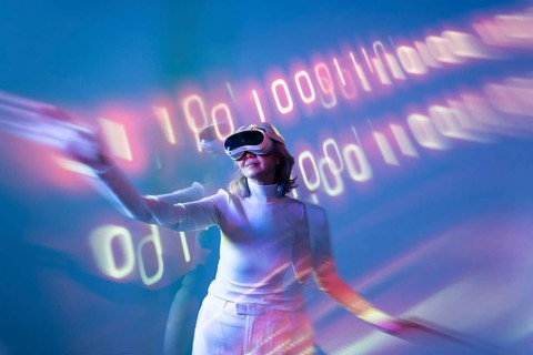 An elderly Asian woman experiences the metaverse using virtual reality technology, engaging with