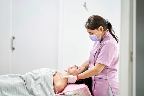 A skilled therapist provides a soothing massage to a client in a modern beauty salon, promoting