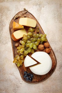 Georgian cheese, Imeretian and smoked suluguni, grapes, nuts, on a cutting board, Georgian cuisine,