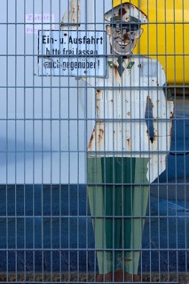 1950s traffic police officer metal sign behind a wire fence, Bavaria, Germany