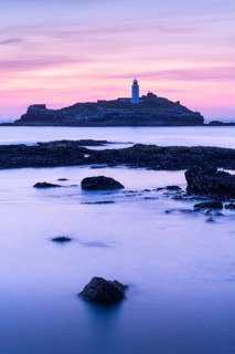 Godrevy Lighthouse, the lighthouse of Godrevy on Godrevy Island. In the evening at sunset. Long