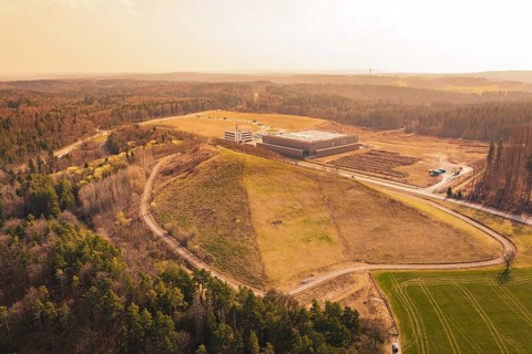 Elevation next to an industrial site, surrounded by roads and forest with a wide view, old deposit