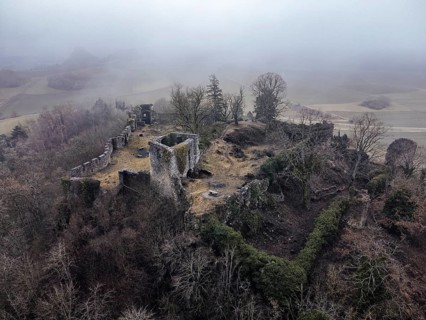 Aerial view of the ruins of Mägdeberg Castle in Hegau on a foggy winter day, Mühlhausen-Ehingen,