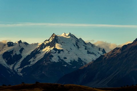 A breathtaking autumn view of Mount Cook in New Zealand with snow capped peaks and a clear blue