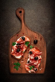 Sandwich with cream cheese, prosciutto with olives, breakfast