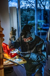 Symbolic image of a burglary, perpetrator has broken into a flat from the garden side and is