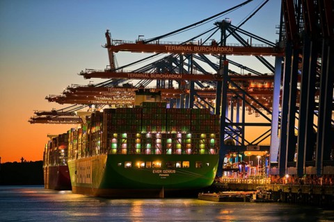 Container terminal Burchardkai with full container ship Ever Genius from Panama in the evening,