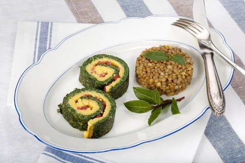Southern German cuisine, polenta spinach roulade with alblentils served on serving platter, bay