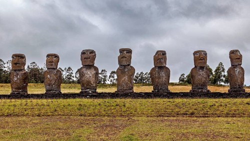 Eight Moai statues in a line on Easter Island against a cloudy sky, The Moai statues on Easter