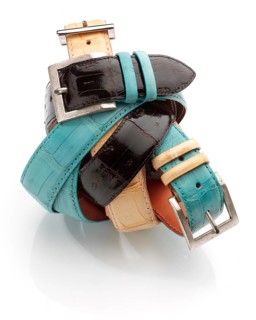Intertwined belts in different colors against a white background, studio shot