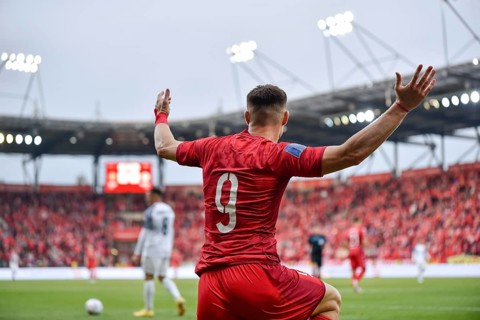 Footballer during soccer match. A gesture with raised hands in Lodz, Poland