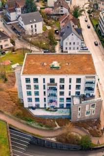 Residential building with green roof, surrounded by residential buildings and roads, Nagold, Calw