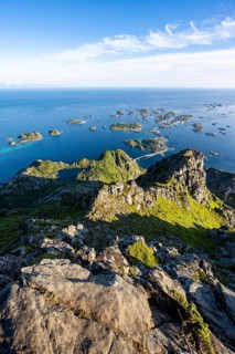 View of numerous small rocky islands with houses, at the summit of Festvågtind, view of