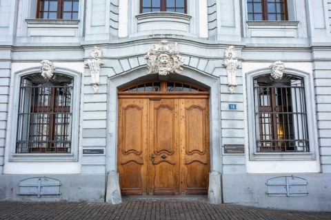Portal with artfully carved wooden door at Reichensteinerhof, Altstadt, Basel, Canton of