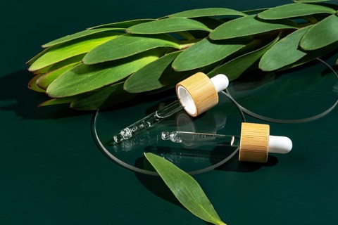 Transparent micellar water for face care captured in a minimalistic pipette bottle, surrounded by