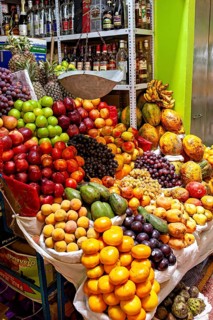 A fruit stand with a colorful selection of fresh fruit in a market, The stalls in the market halls