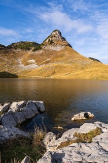 Lake Augstsee and the Atterkogel mountain on the Loser. Rocks in the foreground. Autumn, good