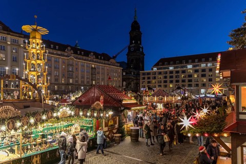Large pyramid at the Striezelmarkt Christmas market on the Altmarkt in Dresden, in the background