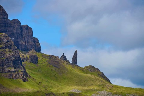 Green hills with jagged rocks under a cloudy sky, Old Man of Storr, Portree, Isle of Skye,
