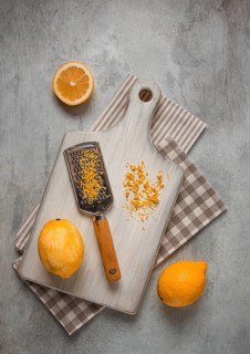 Grated lemon zest, on a cutting board, with a grater, top view, no people