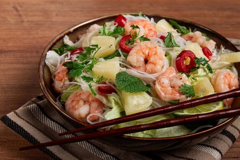 Thai salad with shrimp and rice noodles, pineapple slices, coriander and mint leaves, homemade, no