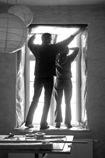 Man and woman renovating a window in an old building, black and white, Othenstorf,