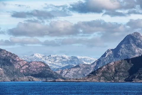 Extensive mountain landscape with mountain ranges of different heights. Behind the darker front