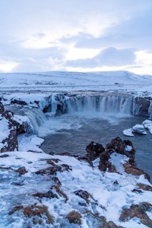Amazing scenery of frozen Godafoss waterfall at sunset in winter, Iceland
