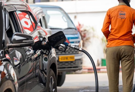 A fuel station attendant refuels a car at a petrol pump in Guwahati, India, on March 11, 2026. Oil