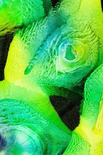 A vibrant abstract image featuring swirling greens and yellows with galaxy, liquids patterns. The