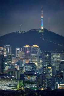 Seoul downtown cityscape illuminated with lights and Namsan Seoul Tower in the evening view from