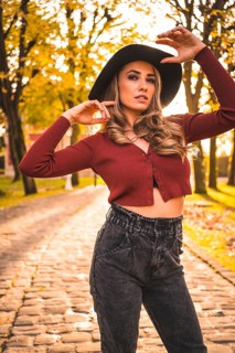 Lifestyle, portrait of a caucasian girl with a hat in a forest walking in autumn