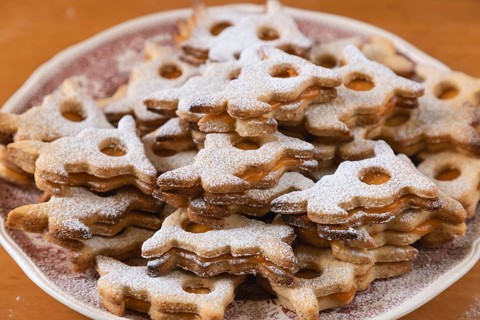 Stacks of Easter bunny shaped cookies dusted with powdered sugar, served on a plate