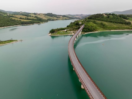 The serene beauty of Lake Castreccioni in Italy. The aerial view highlights its calm waters and the