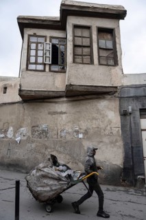 Damascus, Syria. December 10th 2025. An informal rubbish collector working in the streets old