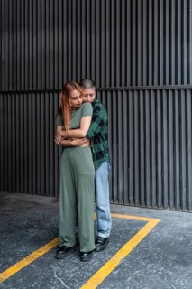 A Colombian lesbian couple embraces lovingly in an urban environment, celebrating LGBTQIA+ pride,