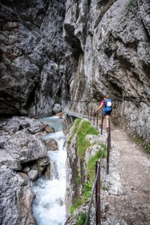 Hammersbach mountain stream in a canyon, mountaineer on a hiking trail in a gorge, Höllentalklamm,
