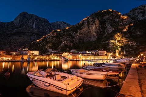MArine in tTown Kotor with view on the city and hills during summer evening, Montenegro.