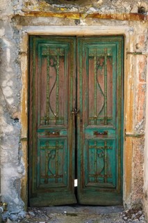 Old weathered front door in an abandoned building, historical building Palazzo Maglioni on the