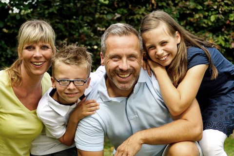 A happy family in the garden, father, mother and two children, boy and girl, 8, 10, 35, 45 years,